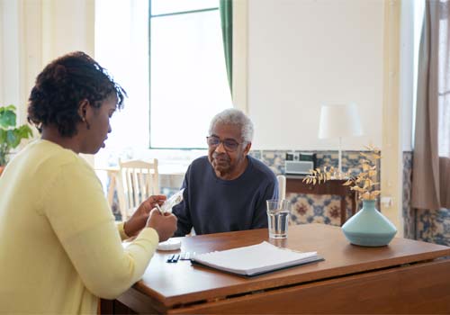nurse talking to an elderly man